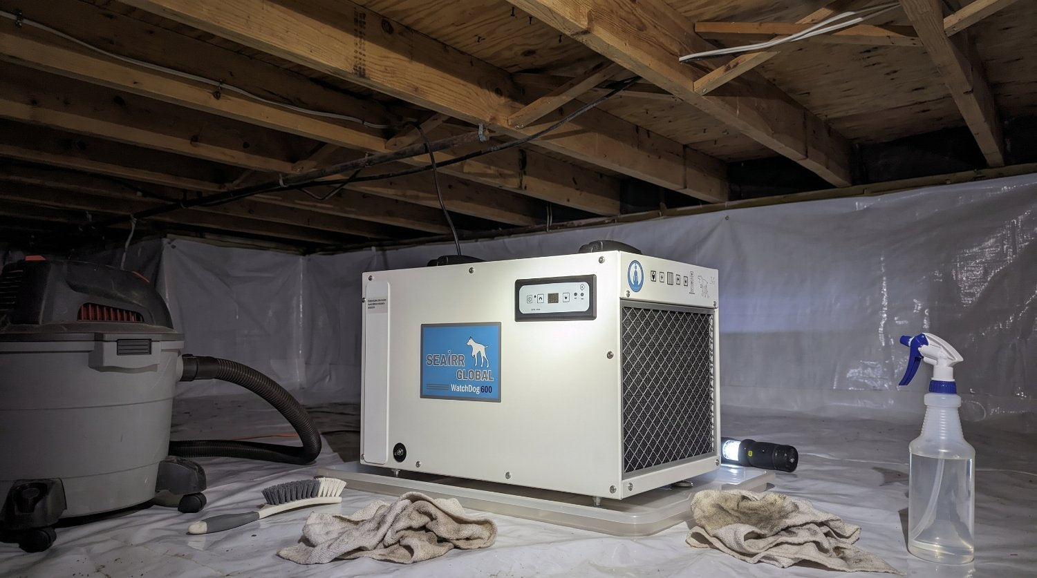 crawl space dehumidifier with a vacuum spray bottles and rags around it