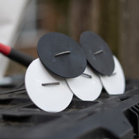 Close-up of three black and white circular objects on a blurred background