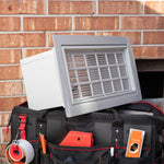 Tool bag with tools and a gray flood vent against a brick wall 