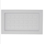 White plastic rectangle with multiple square designs on a white background