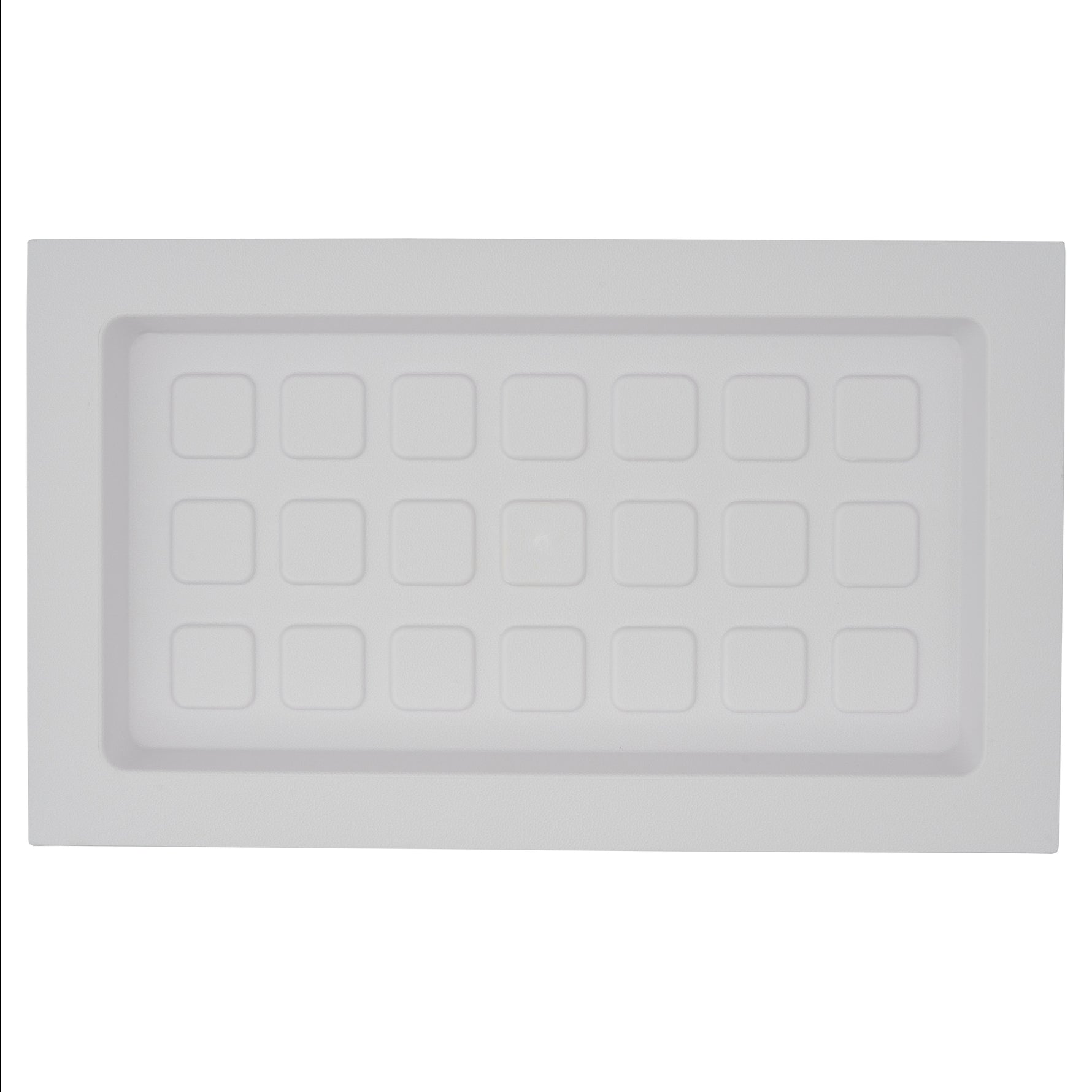 White plastic rectangle with multiple square designs on a white background